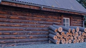 a charming rustic wooden cabin constructed with stacked logs nestled within a peaceful SBI 356632036